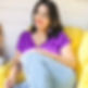 Smiling woman in a yellow armchair (1).png