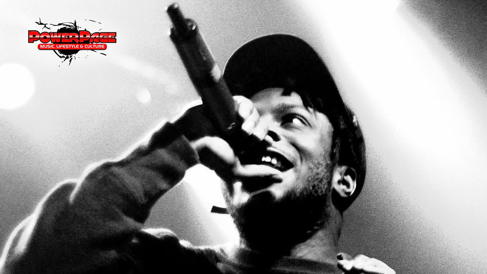 Isaiah Rashad performing onstage with the official PowerPage editorial logo