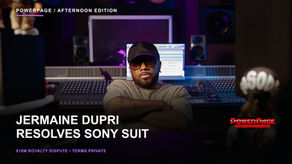 Jermaine Dupri sits in a recording studio with his full head, arms and mixing equipment visible