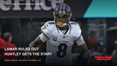 Lamar Jackson wears a helmet and white number 8 Ravens jersey on the field.