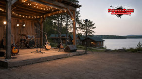 Unoccupied lakeside music camp stage used as a PowerPage editorial illustration
