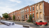 Illustration: Baltimore rowhouses and redevelopment plans representing the Baltimore Vacants Reinvestment Council meeting.