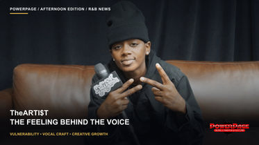 TheARTI$T sits on a brown couch holding an interview microphone.