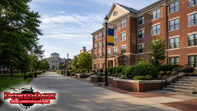 An empty Baltimore university walkway with red-brick buildings and blue-and-gold banners.