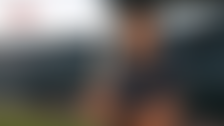 AI-generated PowerPage Sports editorial likeness of Samuel Basallo holding a bat in an empty, unbranded professional ballpark training setting.