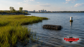 Chesapeake Bay marsh, oyster restoration cage and treatment infrastructure with the official PowerPage logo.