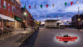 Prepared festival infrastructure on a Baltimore Little Italy streetscape with the official PowerPage logo