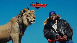 Hit-Boy sits beside a lion against a bright blue backdrop, with the PowerPage logo above them.