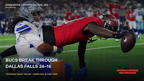A Buccaneers player in a red jersey extends the football toward an orange pylon while a Cowboys defender makes a tackle.