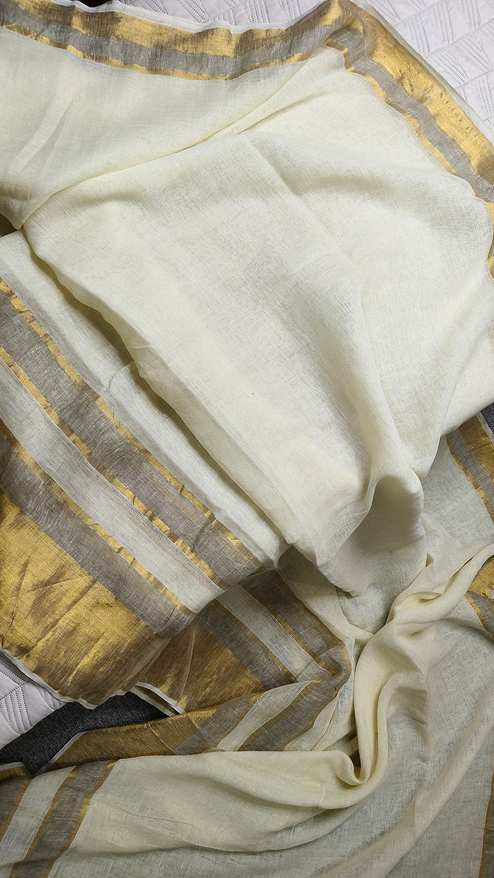 Thin golden border on off white linen saree