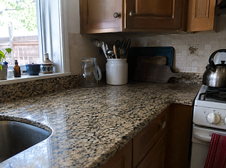 Durable beige granite countertop in a lived-in kitchen