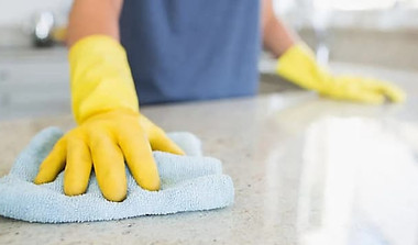 Cleaning and polishing quartz countertop with cloth, proper maintenance and care techniques