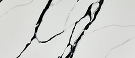Close-up of Calacatta Lumanyx quartz showing bold ink-black veining detail