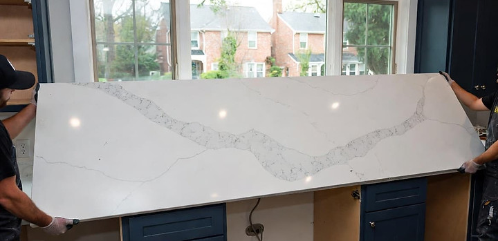 Quartz countertop installation in progress at a Toronto kitchen with fabricator positioning the slab