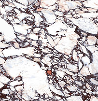 Calacatta Viola porcelain countertop close-up, bold violet and burgundy veining on white, Toronto
