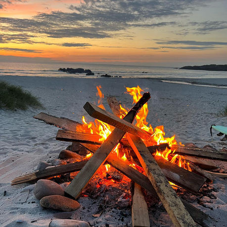 Bonfire at sunset on the beach of Scarinish Island