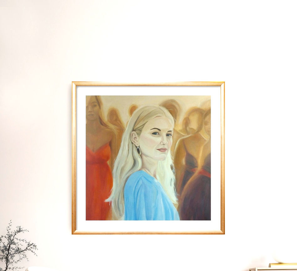 A beautiful self-assured blond woman standing at the front of a blurred crowd.