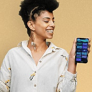 Lady hold the myndlift app to show brain training results after doing neurofeedback sessions