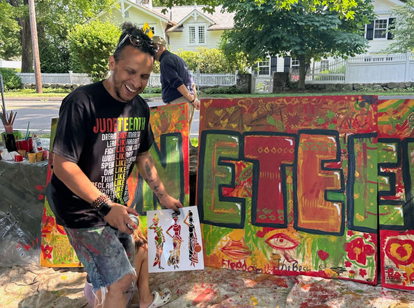 Local Artist, 5iveFingaz, Leads Community in Mural Painting