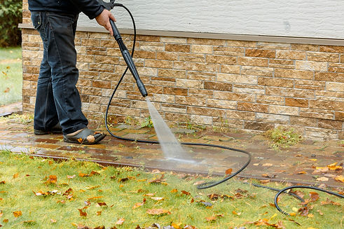 man-cleaning-street-with-high-pressure-power-washer-washing-stone-garden-paths.jpg