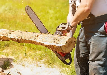 man-saws-piece-wood-with-chainsaw-working-with-gasoline-chain-saw-closeup-chainsaw-started