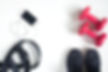 Flat lay of cellphone, red dumbbells and