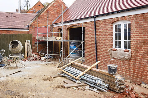 Building site in UK with brick house extension under construction.jpg