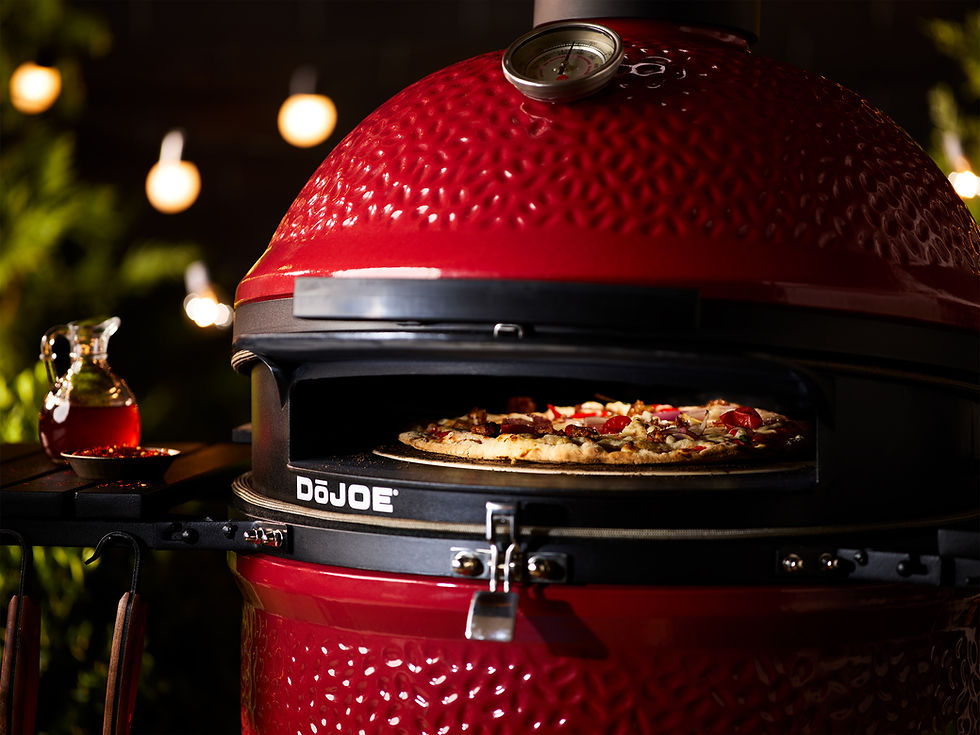Pizza baking on a Kamado Joe grill using the DoJoe attachment