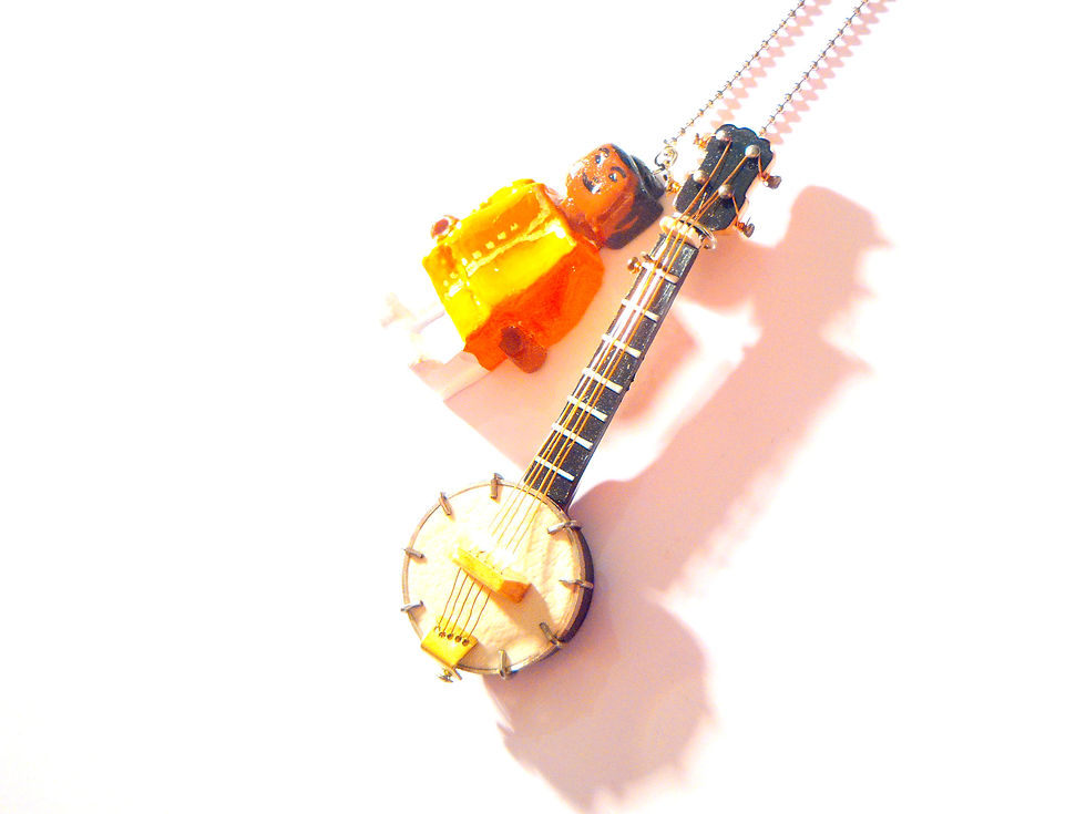 Thumbnail: bijou avec bonhomme orange miniature sixties musique