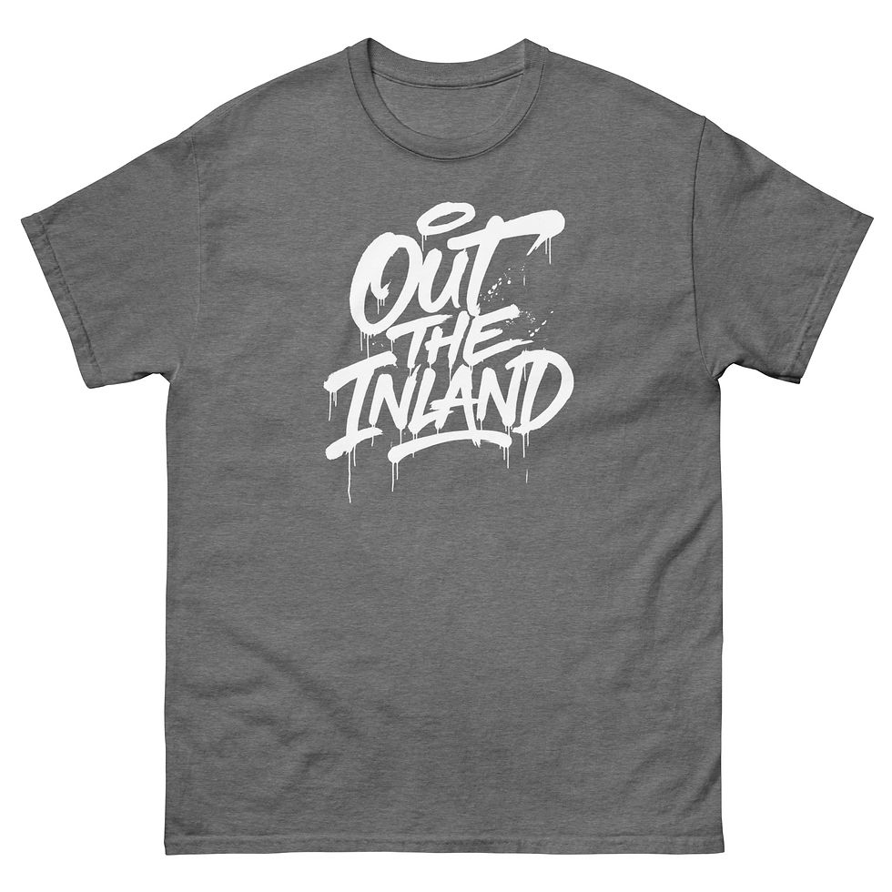 Thumbnail: White "Out the Inland" graffiti-style graphic printed on a grey T-shirt featuring bold hand-lettered brush script