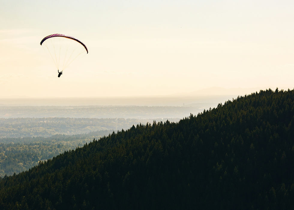 a person paragliding near a mountain