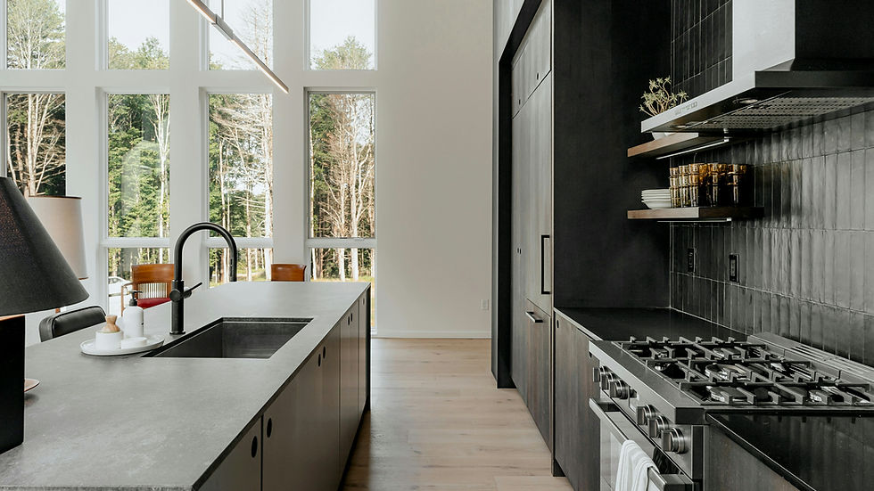 A kitchen with stove top oven next to a window