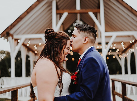 Groom kisses bride on forehead after their wedding in greenwood, missouri