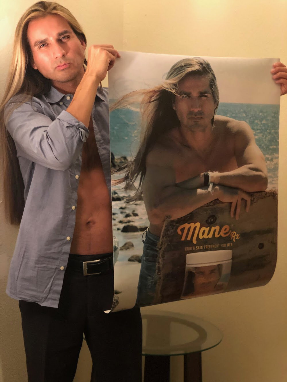 Cesar Valdizan founder of super seed international holding up a Mane Rx poster