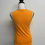 Miniaturbild: Orange top on a mannequin, sleeveless shirt, simple design, neutral background.