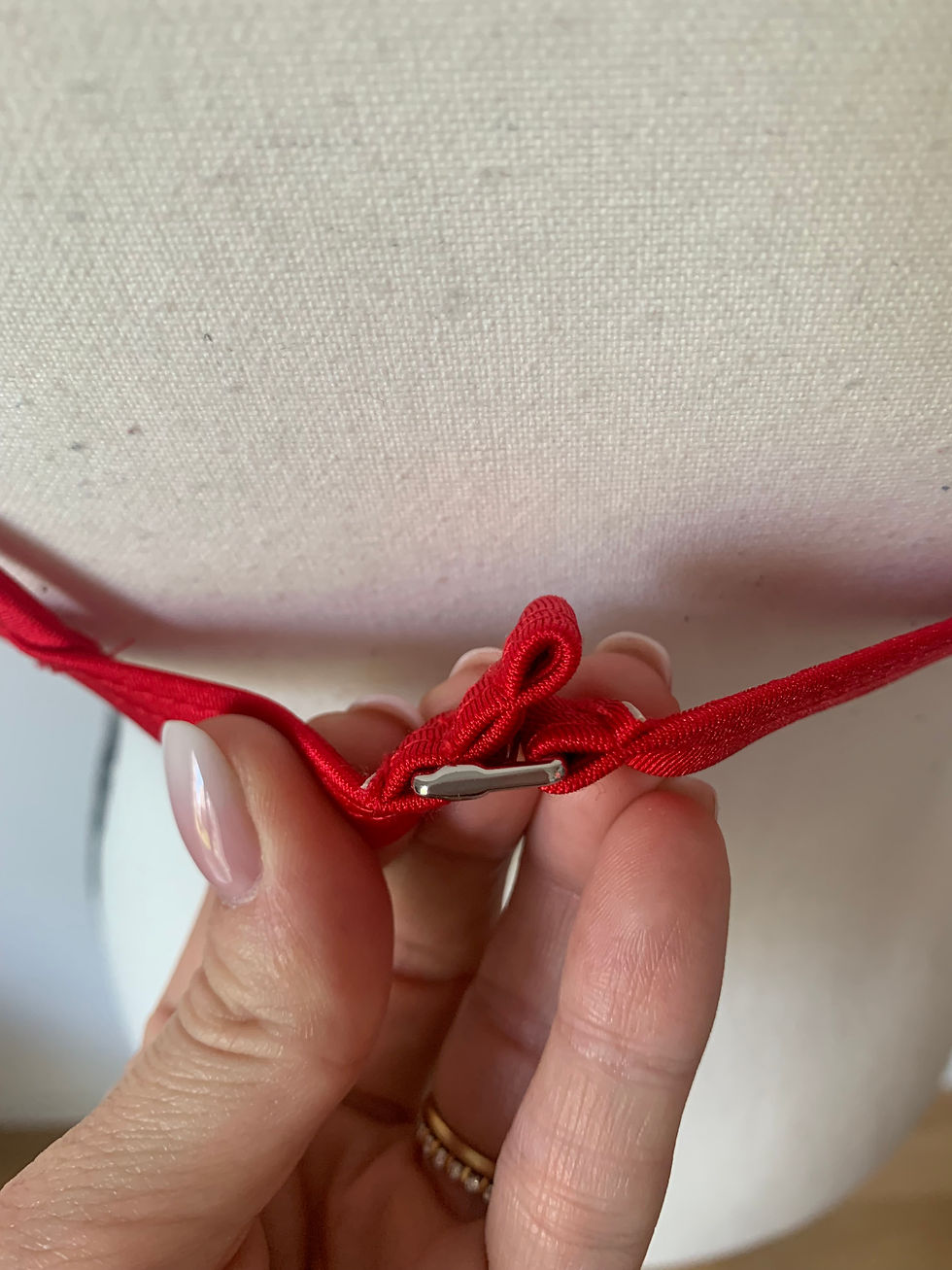 Miniaturbild: Nahaufnahme einer roten Schnalle, die von einer Hand gehalten wird, Nahaufnahme