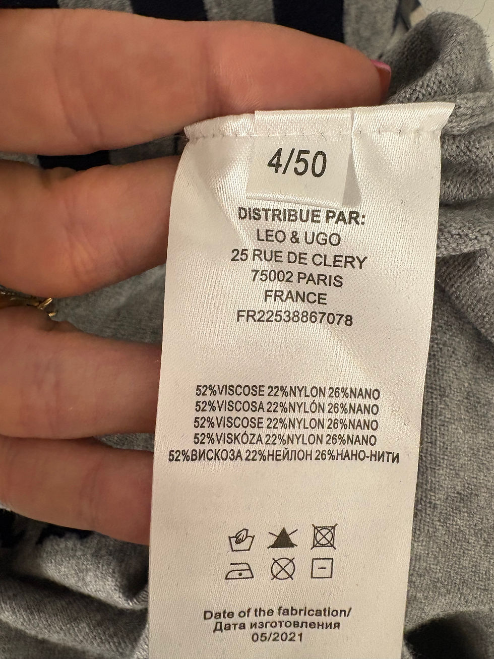 Miniaturbild: White clothing tag with text: 4/50, LEO & UGO, and material details.