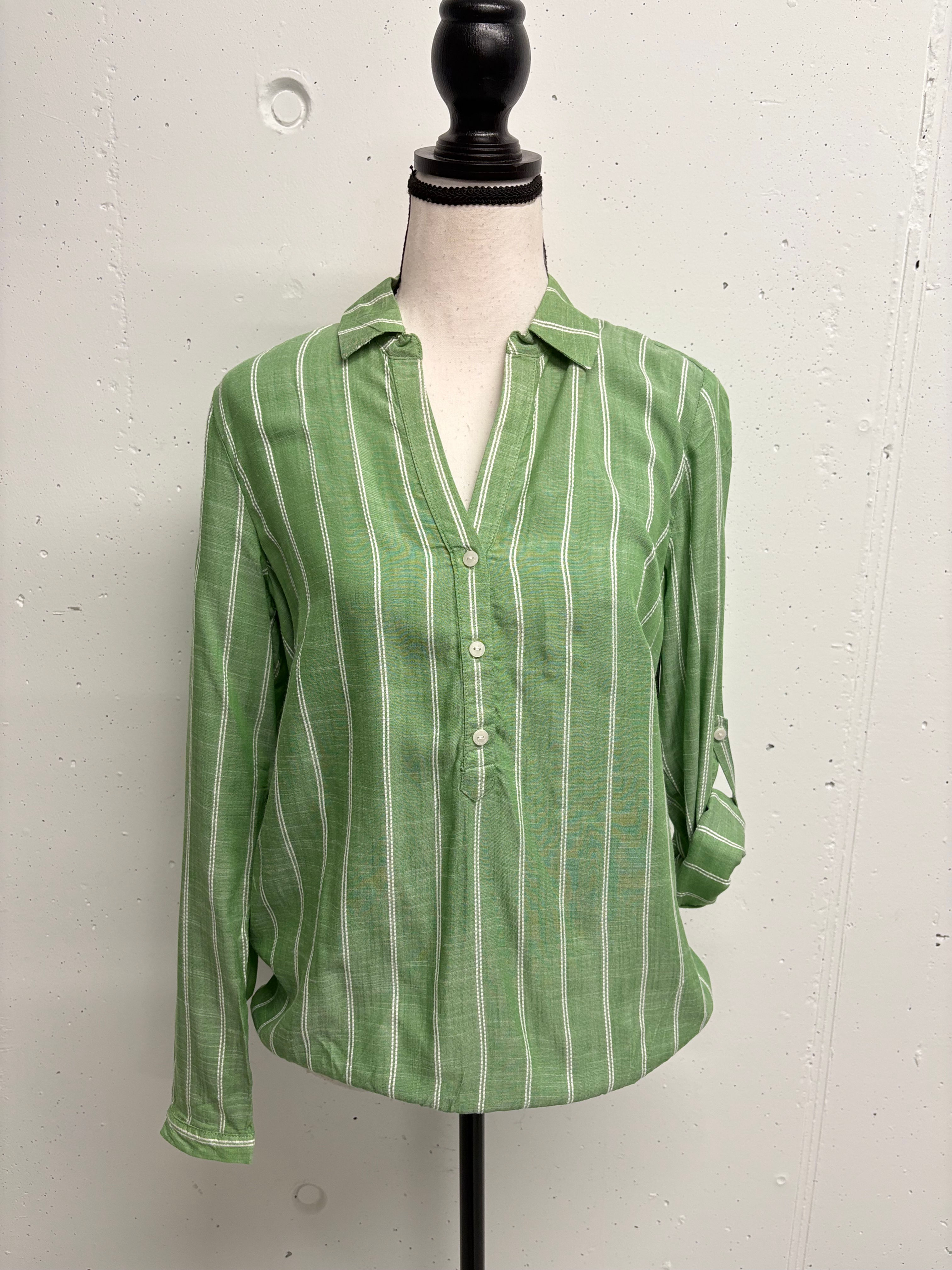 Green striped shirt on a mannequin, three buttons, folded sleeves. 
