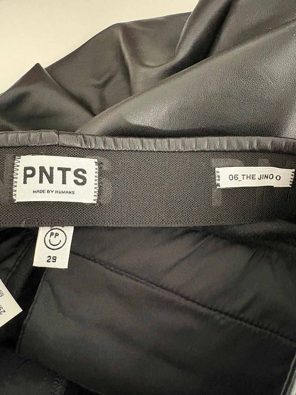 Miniaturbild: PNTS MADE BY SUNDAY, 08_THE JINGO, and smiley face logo on black pants, size 29.