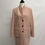Miniaturbild: Blush pink coat on mannequin with three black buttons and pockets