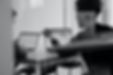 Two people sat at table with laptops having a meeting.