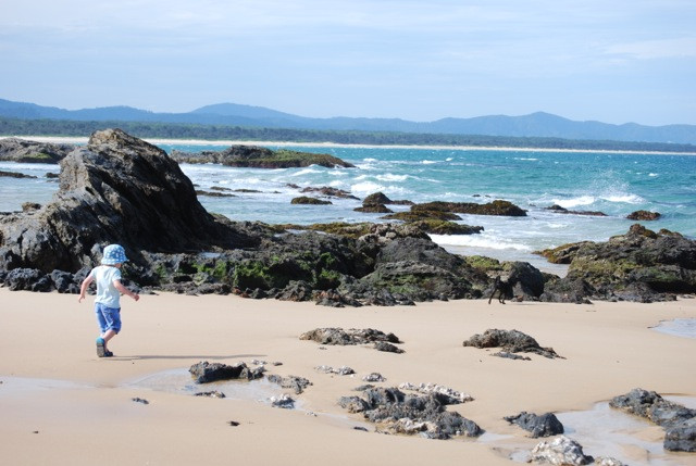Exploring rocks on North Beach, Mylestom New South Wales Australia