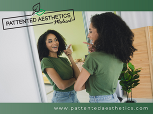 Woman pointing at herself in the mirror and smiling.