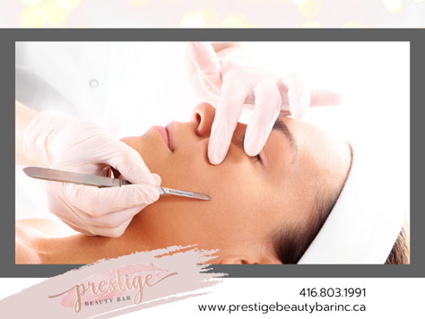 Close-up of a woman’s face who is receiving a dermaplaning treatment.