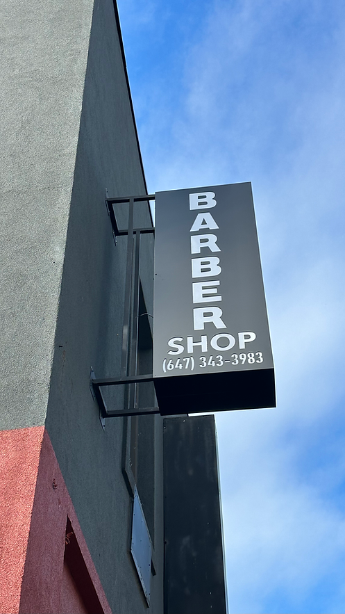 Optimism Barbershop sign on Bloor St