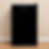 Frigobar preto Midea com design clean encostado em parede neutra.