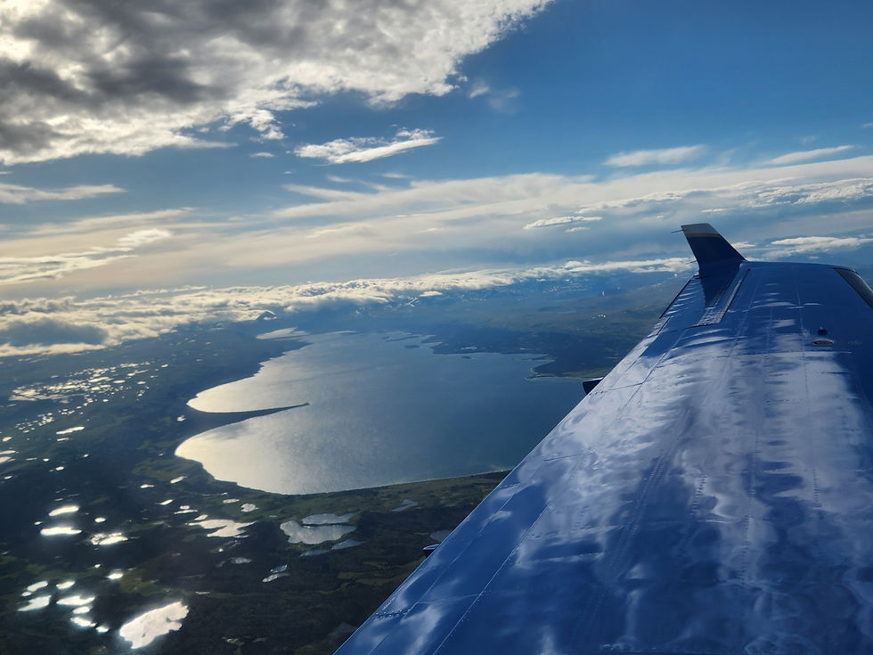 Airplane wing over rural Alaska viewing the Alaskan landscape.