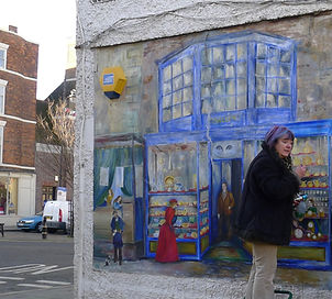 Louth shop mural repaint on Queen Street November 2012. Artist painting.