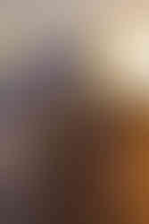 A fishing line collection station with fishing line hanging out of the container on a fishing jetty with the sunrise in the background