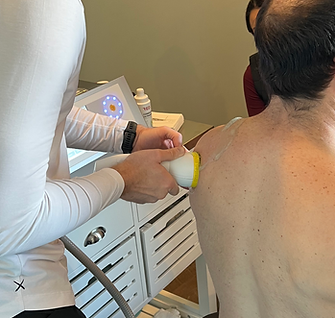 SoftWave Therapy being applied to a mans shoulder
